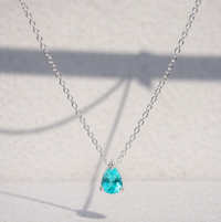 Paraiba Tourmaline Pear Cut Pendant Necklace on a white background